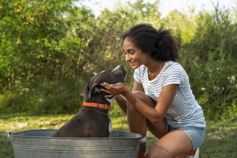 smiley-woman-washing-dog-full-shot